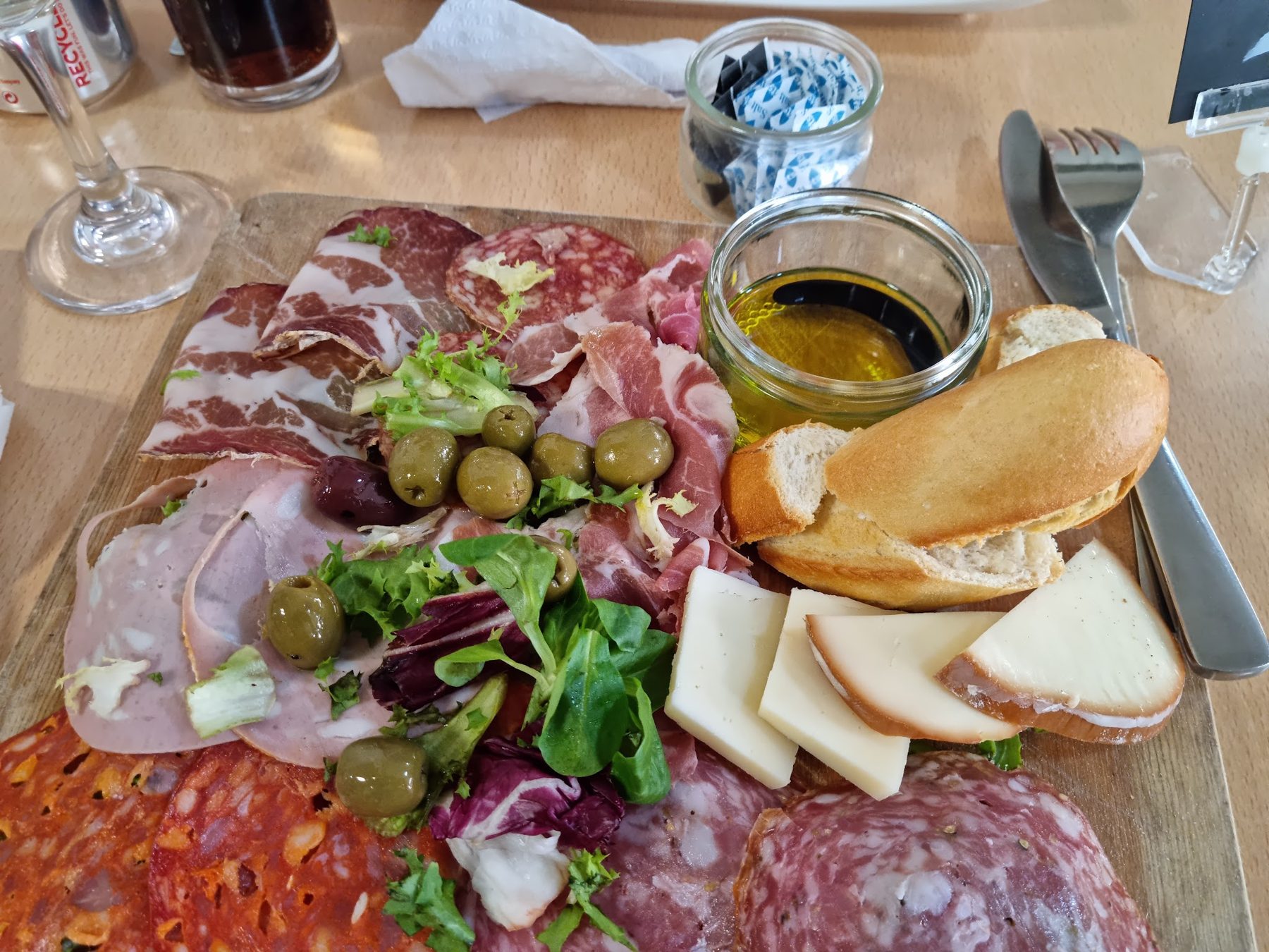 A board of Italian cured meats, cheese, olives and bread